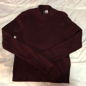 Maroon mock-neck ribbed sweater.